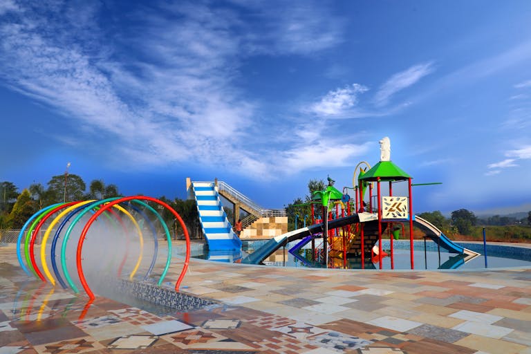 Vibrant water playground with slides and mist tunnels in Jabalpur, India.